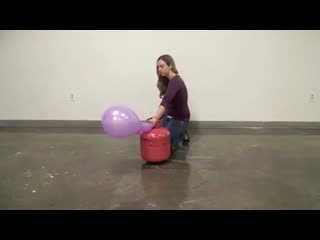 girl puts purple balloon to the test on helium tank echoing bang